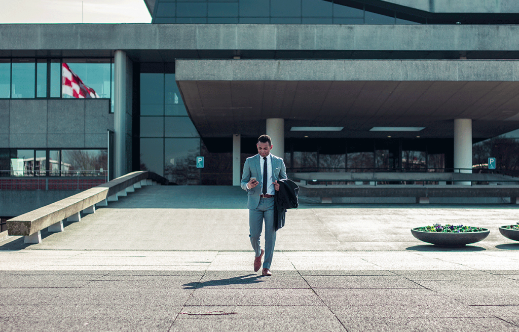 man in a suit walking out of a building